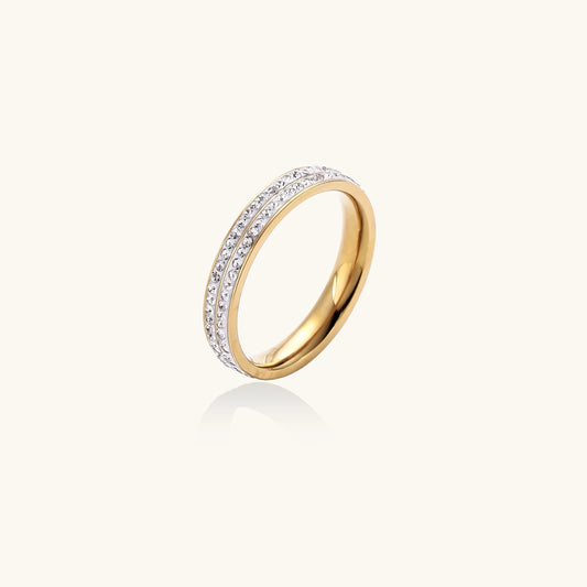 Gold ring with embedded diamonds on a white background