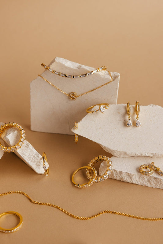 a white box with gold jewelry on it seravine atelier