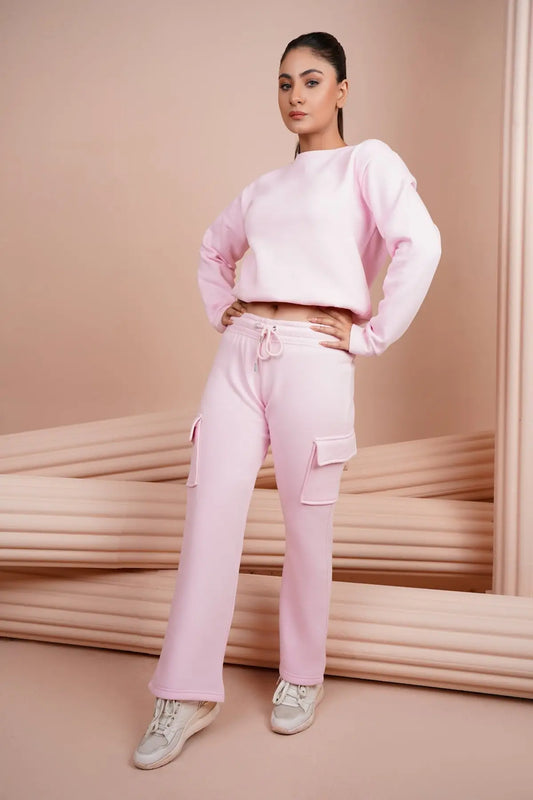 a woman wearing pink pants and a pink sweater