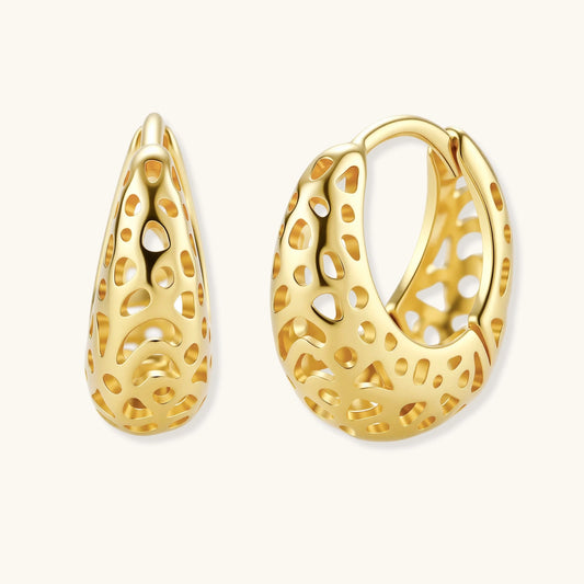 Gold hoop earrings with intricate designs on a white background