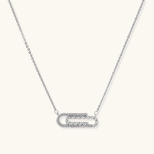 Silver necklace with a unique pendant on a white background