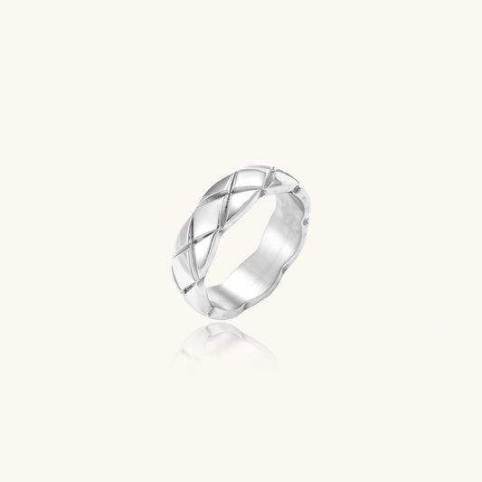 Silver ring with a geometric design on a white background