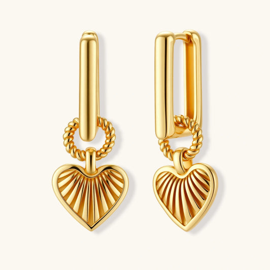 Gold heart-shaped earrings on a white background