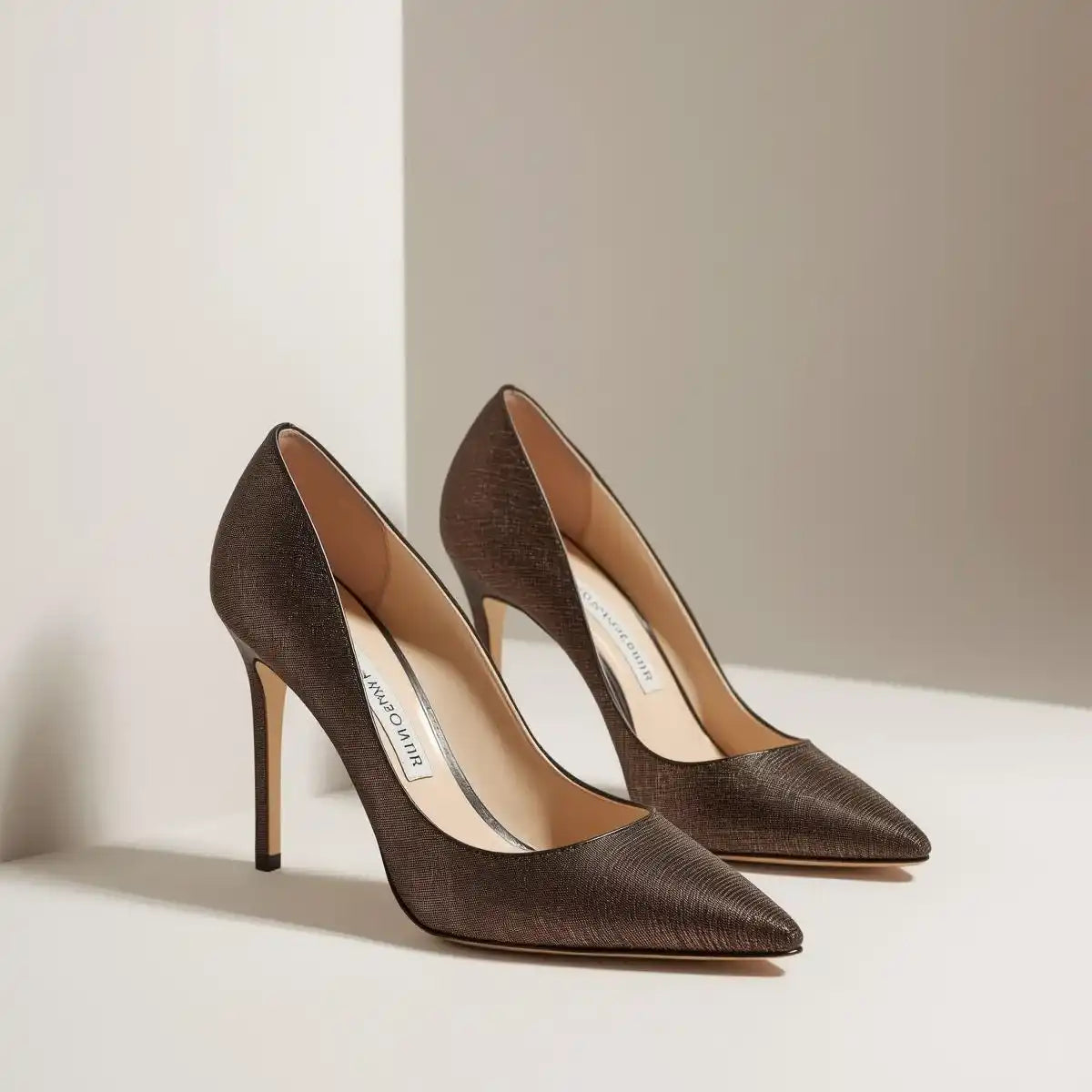 Pair of brown high-heeled shoes on a light background